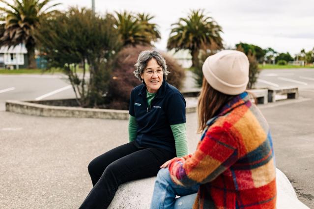 two people having a conversation outdoors