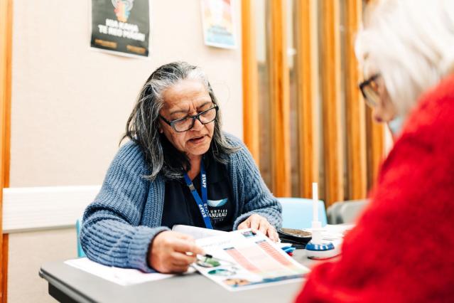 A person being shown a plan to quit smoking by a professional