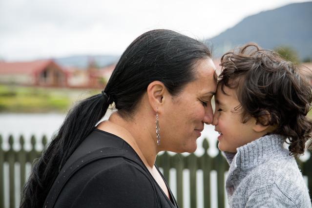 A mother touching her child's face with her nose