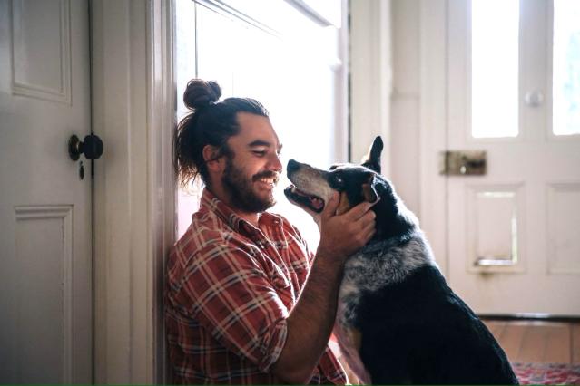 a man embracing a dog, a still from the Quit for your Pets TV commercial