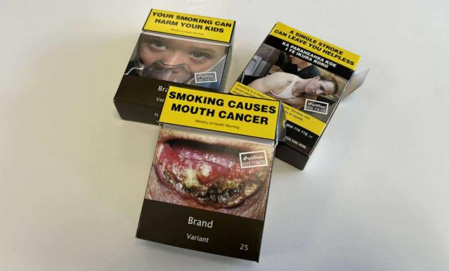 Samples of cigarette boxes with health messages on them, including images of stroke and tooth decay..