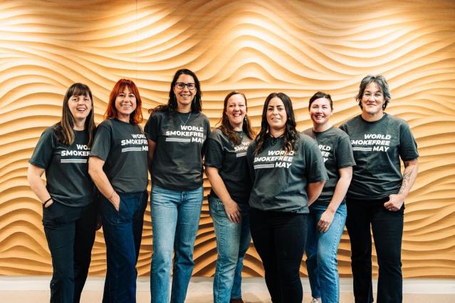 A group of people standing facing outwards in World Smokefree May t-shirts